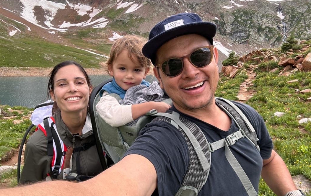 Founders Veronica and Diego hiking in the mountains with their young child.